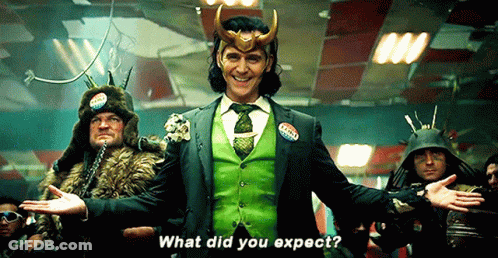 A Man In A Green Suit And Tie Is Standing In Front Of A Group Of Men And Says What Did You Expect . GIF