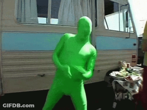 A Man In A Green Suit Is Dancing In Front Of A Camper GIF
