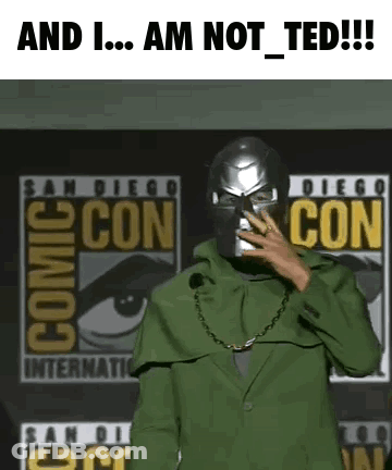 A Man In A Green Suit Is Standing In Front Of A Comic Con Sign . GIF
