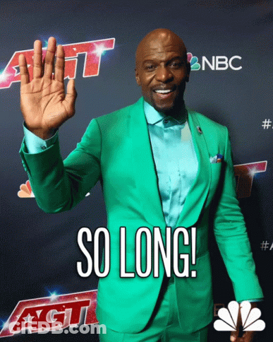 A Man In A Green Suit Is Standing In Front Of A Sign That Says Nbc GIF
