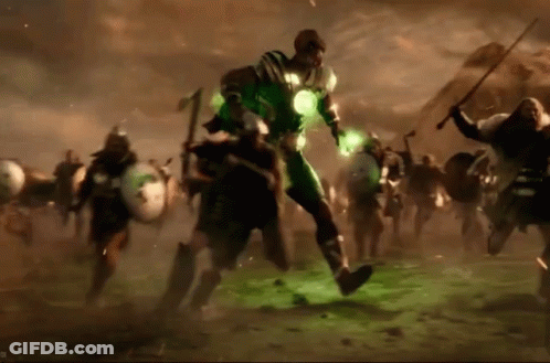 A Man In A Green Suit Is Surrounded By A Group Of Men GIF