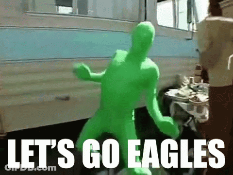 A Man In A Green Suit Says Let 'S Go Eagles In White Letters GIF