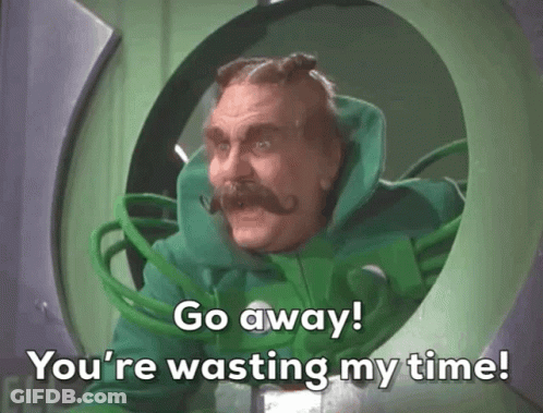 A Man In A Green Suit With A Mustache Says Go Away You 'Re Wasting My Time GIF
