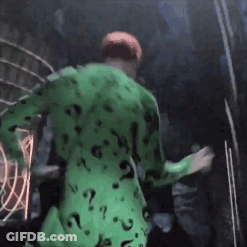 A Man In A Green Suit With Question Marks On It GIF
