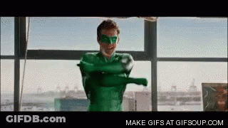 A Man In A Green Superhero Costume Is Standing In Front Of A Large Window . GIF