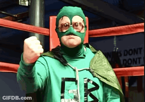 A Man In A Green Superhero Costume With The Letter B On The Front GIF