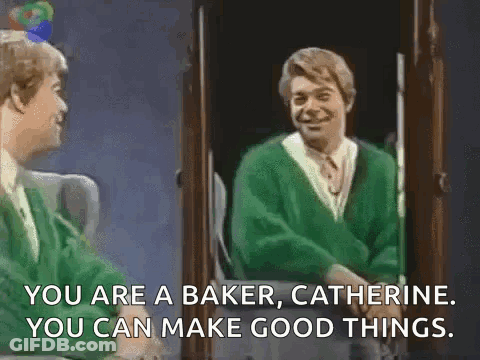 A Man In A Green Sweater Is Standing In Front Of A Mirror And Talking To Another Man . GIF
