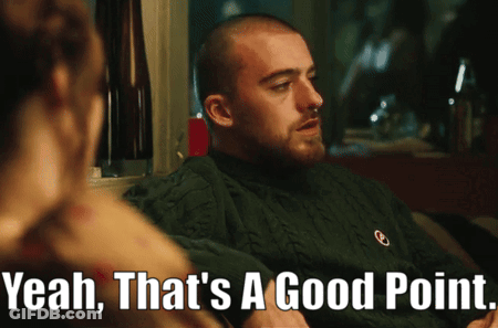 A Man In A Green Sweater Says " Yeah That 'S A Good Point " In Front Of A Woman GIF