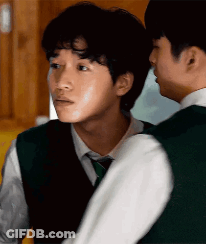 A Man In A Green Vest And Tie Is Standing Next To Another Man In A White Shirt GIF