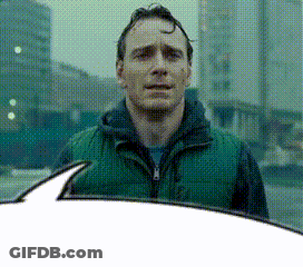 A Man In A Green Vest Is Standing In Front Of A Building GIF