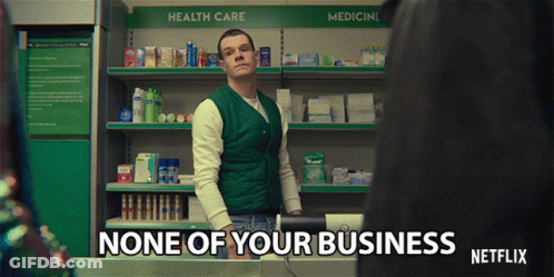 A Man In A Green Vest Is Standing In Front Of A Shelf That Says Health Care GIF