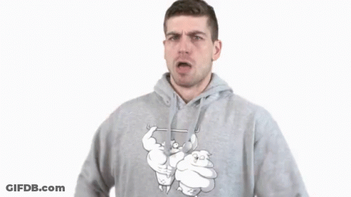 A Man In A Grey Hoodie Is Making A Gesture GIF