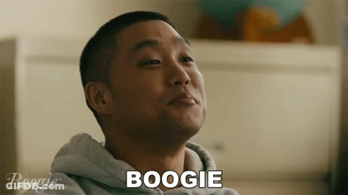 A Man In A Grey Hoodie Says Boogie In Front Of Him GIF