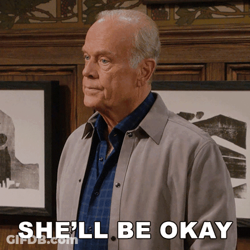A Man In A Grey Jacket Says She 'Ll Be Okay In Front Of Framed Pictures GIF