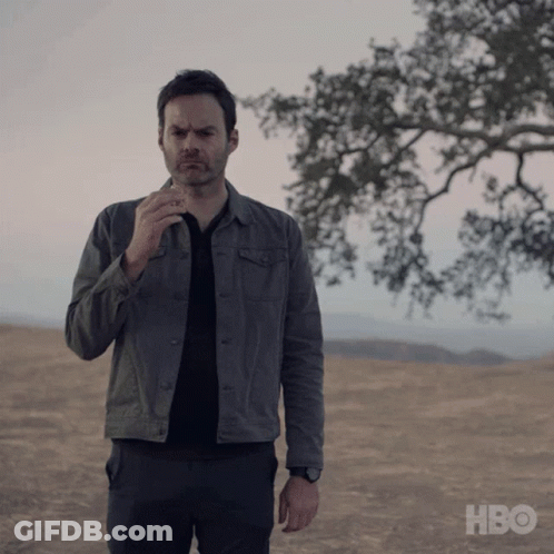 Man In Grey Jacket In Field With HBO GIF