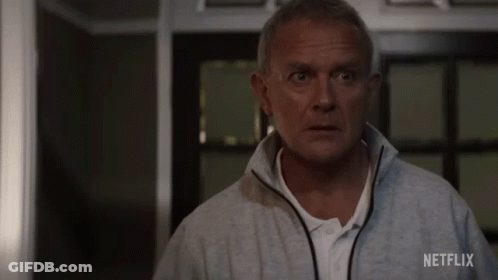 A Man In A Grey Jacket With Netflix Written On The Back GIF
