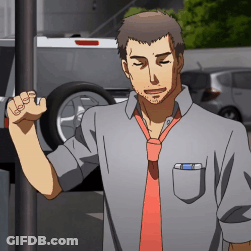 A Man In A Grey Shirt And Red Tie Stands In Front Of A Car GIF