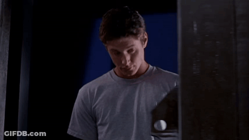 A Man In A Grey Shirt Holds A Golf Ball GIF