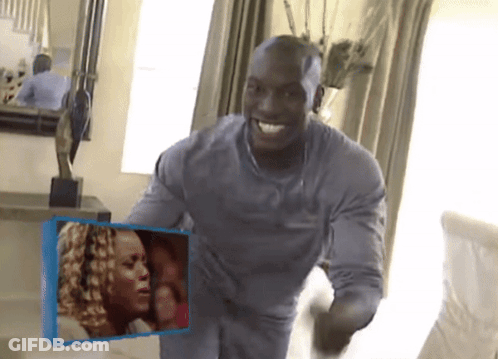 A Man In A Grey Shirt Is Holding A Picture Of A Woman GIF