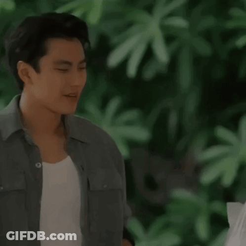 A Man In A Grey Shirt Is Praying With His Hands Folded GIF