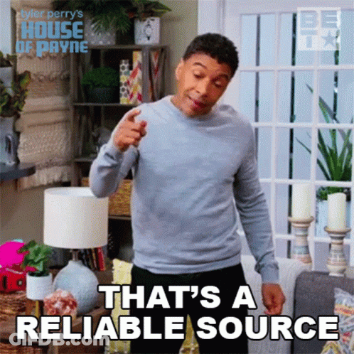 A Man In A Grey Sweater Is Pointing At The Camera And Saying That 'S A Reliable Source . GIF