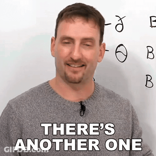 A Man In A Grey Sweater Says There 'S Another One In Front Of A White Board GIF