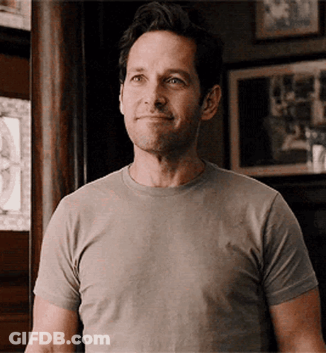 Smiling Man In Grey T-Shirt Looking At Camera GIF