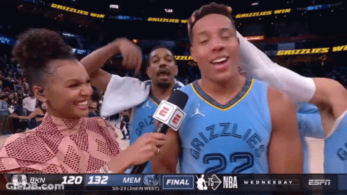 A Man In A Grizzlies Jersey Is Interviewed By A Reporter GIF