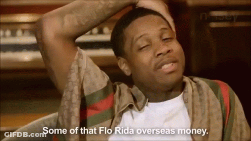A Man In A Gucci Shirt Is Sitting In Front Of A Piano And Says Some Of That Flo Rida Overseas Money . GIF