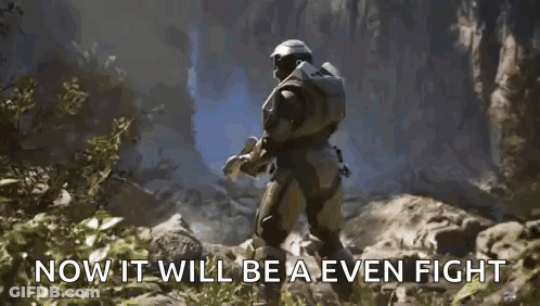 A Man In A Halo Armor Is Holding A Blue Object In His Hand . GIF