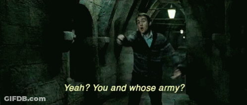 A Man In A Harry Potter Movie Is Standing In A Dark Hallway And Talking To Another Man . GIF