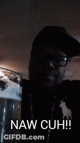 A Man In A Hat And Glasses Is Holding A Glass Of Beer And Says Naw Cuh ! GIF