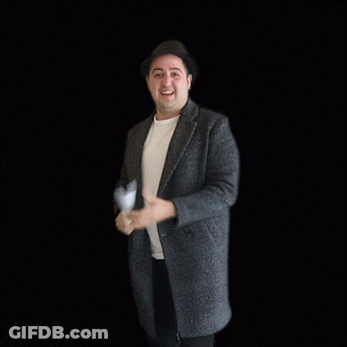 A Man In A Hat Holds A Piece Of Paper In Front Of A Sold Sign GIF
