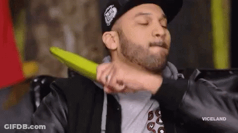 A Man In A Hat Is Being Punched In The Face By Another Man . GIF