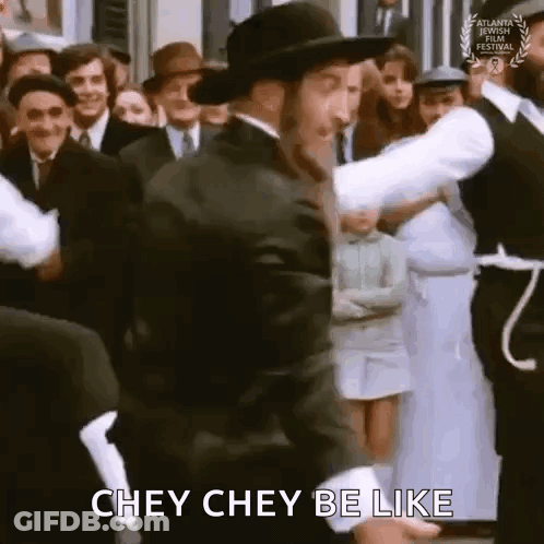 A Man In A Hat Is Dancing In Front Of A Crowd Of People And Saying Chey Chey Be Like . GIF