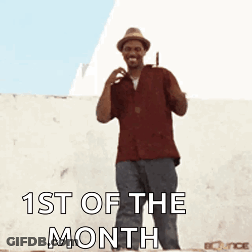 A Man In A Hat Is Dancing With The Words 1St Of The Month GIF