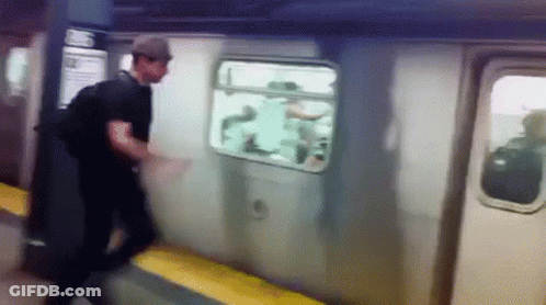 A Man In A Hat Is Getting Off A Subway Car GIF