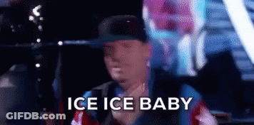 A Man In A Hat Is Holding A Balloon And Says `` Ice Ice Baby '' While Standing In A Car . GIF