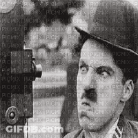 A Man In A Hat Is Holding A Camera And Looking At The Camera . GIF