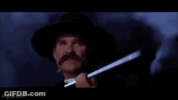 A Man In A Hat Is Holding A Gun And Saying Clouds Comin ' With Me . GIF