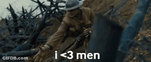 A Man In A Hat Is Holding A Rifle In A Field And Says `` I < 3 Men '' . GIF