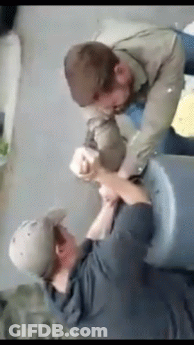 Man In Hat Holding Another's Arm GIF