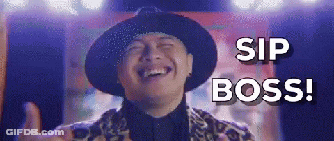 A Man In A Hat Is Laughing And Giving A Thumbs Up While Saying `` Sip Boss '' . GIF