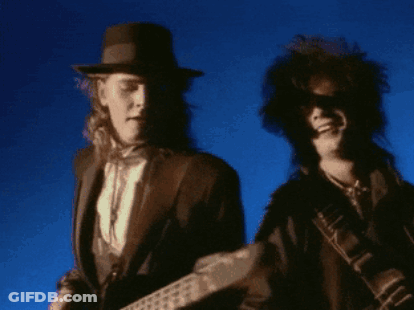 Man In Hat Playing Guitar Next To Man In Sunglasses GIF