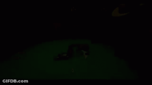 A Man In A Hat Is Playing Poker With A Gun On The Table GIF