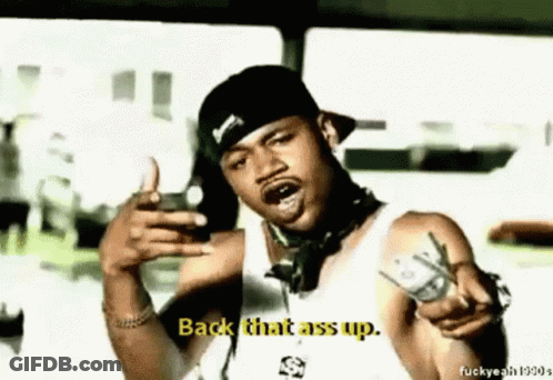 A Man In A Hat Is Pointing At The Camera And Says Back That Ass Up . GIF