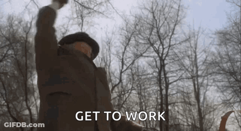 A Man In A Hat Is Raising His Fist In The Air . GIF