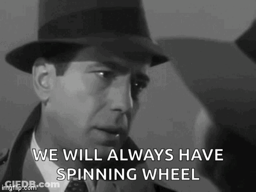 A Man In A Hat Is Saying `` We Will Always Have Spinning Wheel '' In A Black And White Photo . GIF