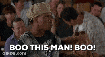 A Man In A Hat Is Sitting In A Crowd And Says Boo This Man Boo ! GIF