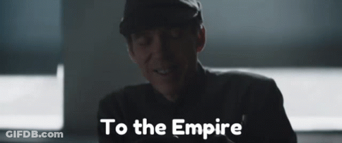 A Man In A Hat Is Smiling And The Words To The Empire Are Behind Him GIF